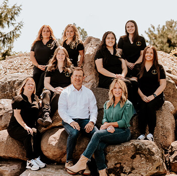 Smiling orthodontic team member in Rochester at computer