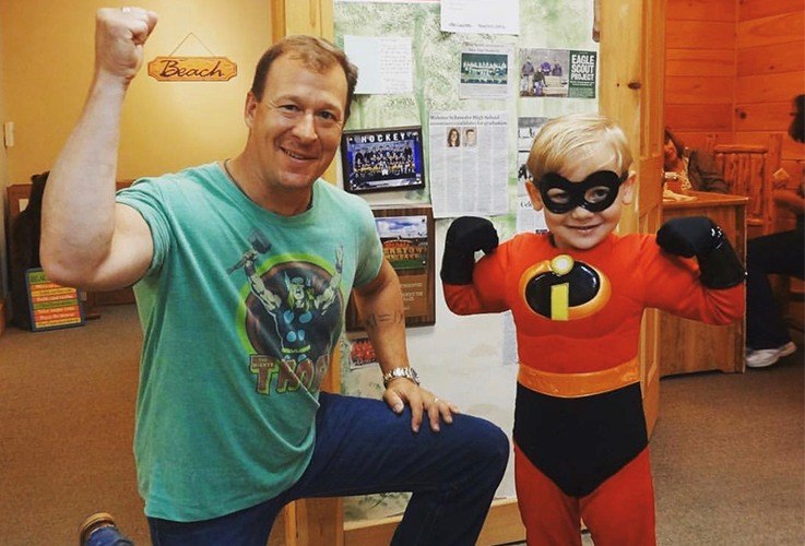 Dr. Drabik posing with a child in an Incredibles costume